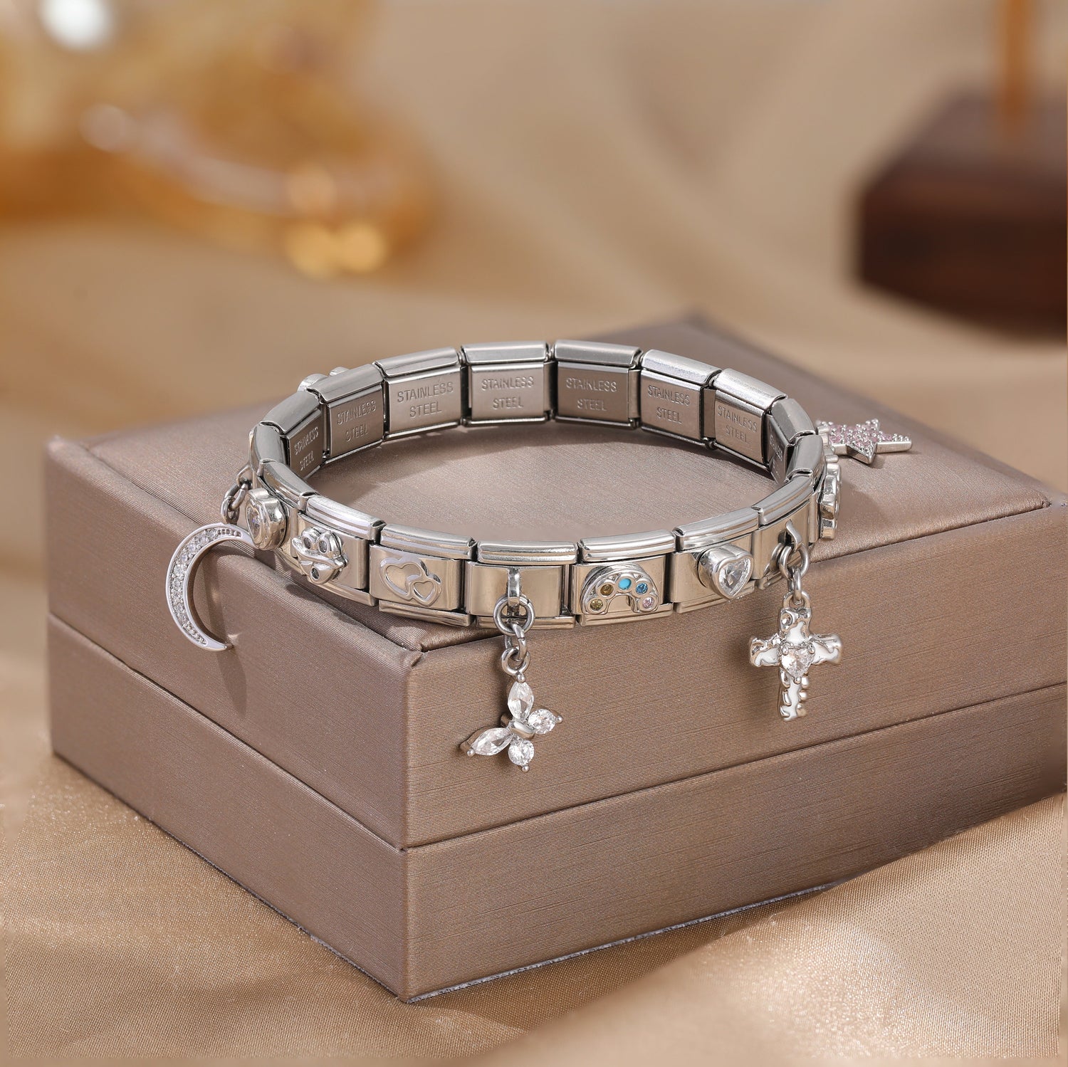 Silver Italian charm bracelet with cross and moon charms displayed on a jewelry box, showcasing elegant personalized Italian charm jewelry