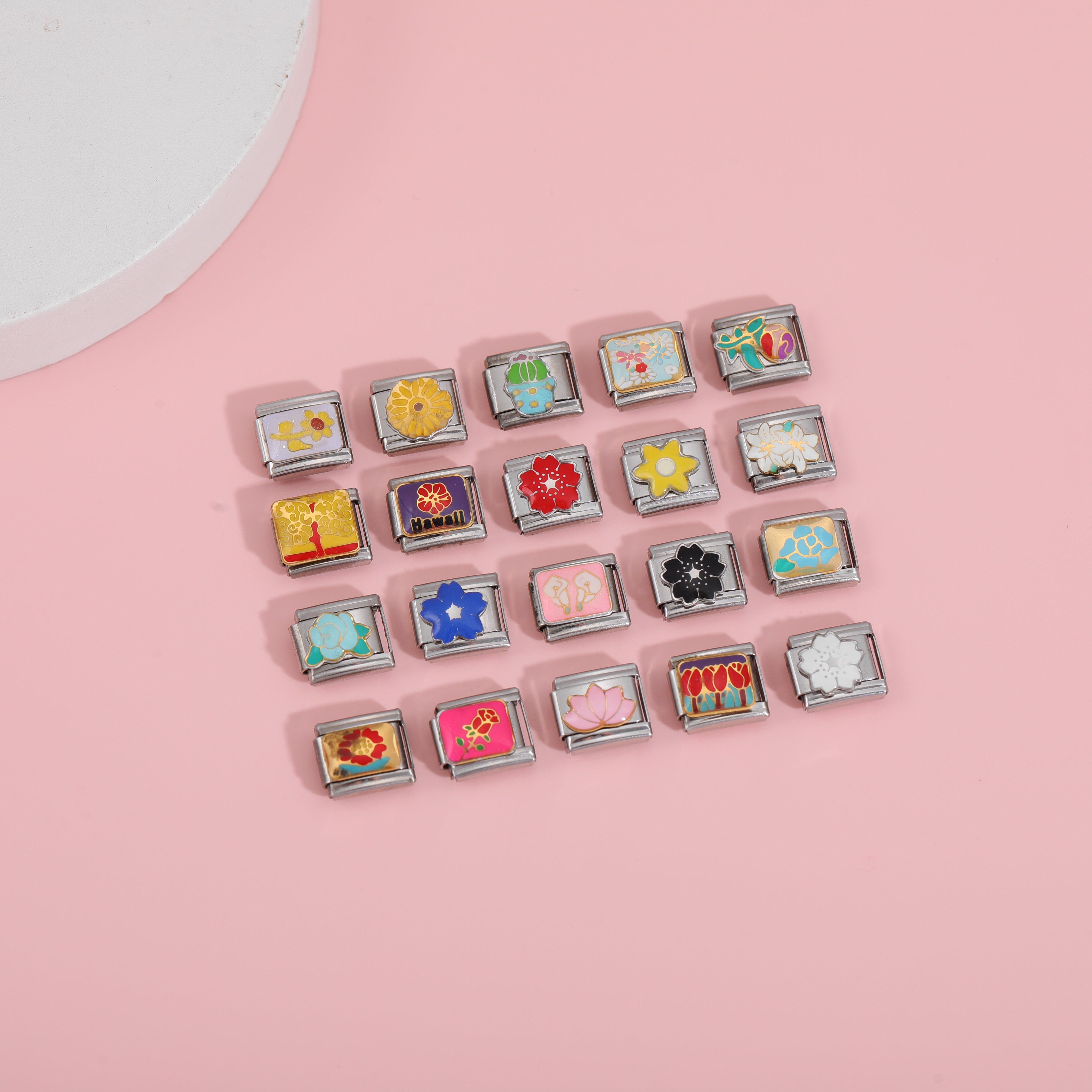 colorful flower italian charm bracelet charms collection on pink background flat lay