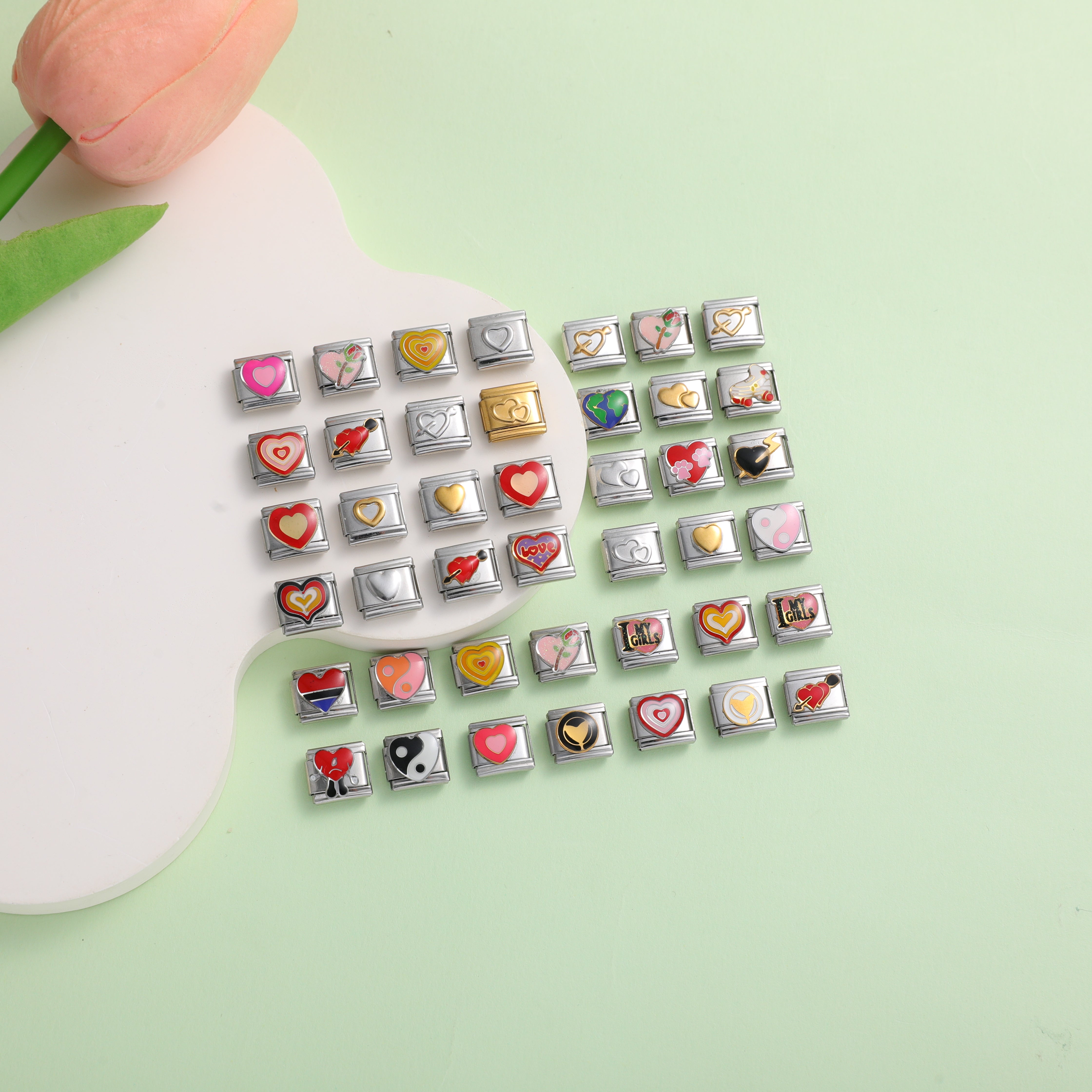 assorted heart italian charm bracelet links with romantic and love symbols on green background