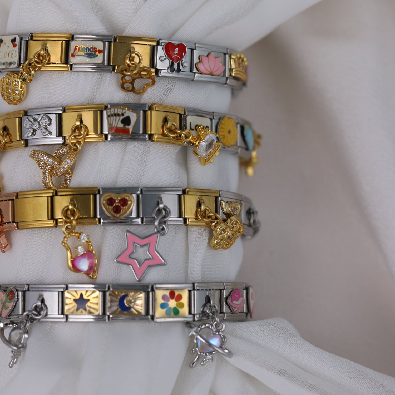 Stacked Italian charm bracelets with gold and silver links, featuring personalized Italian charm designs and custom bracelet details