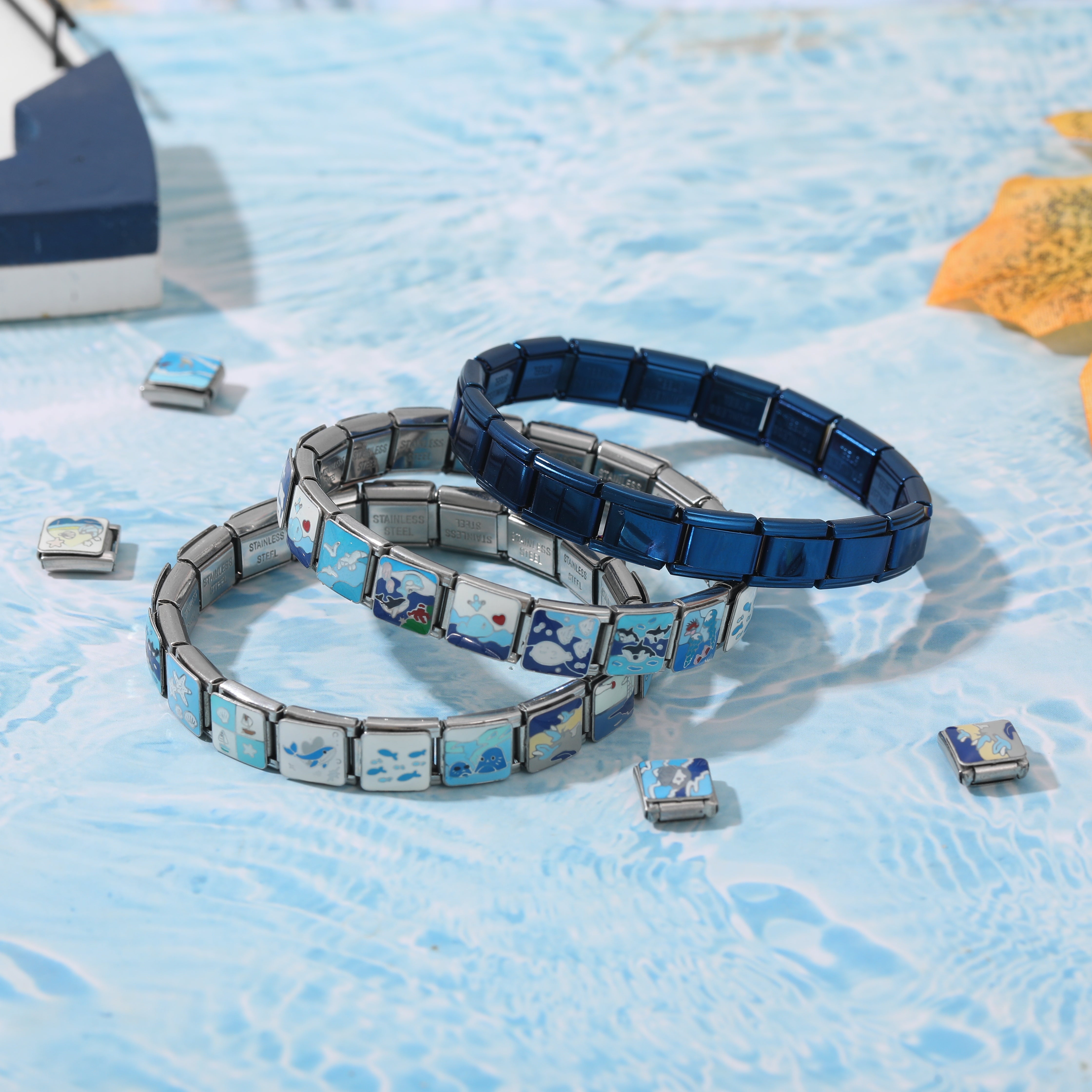 stacked italian charm bracelets with ocean blue charms and stainless steel links