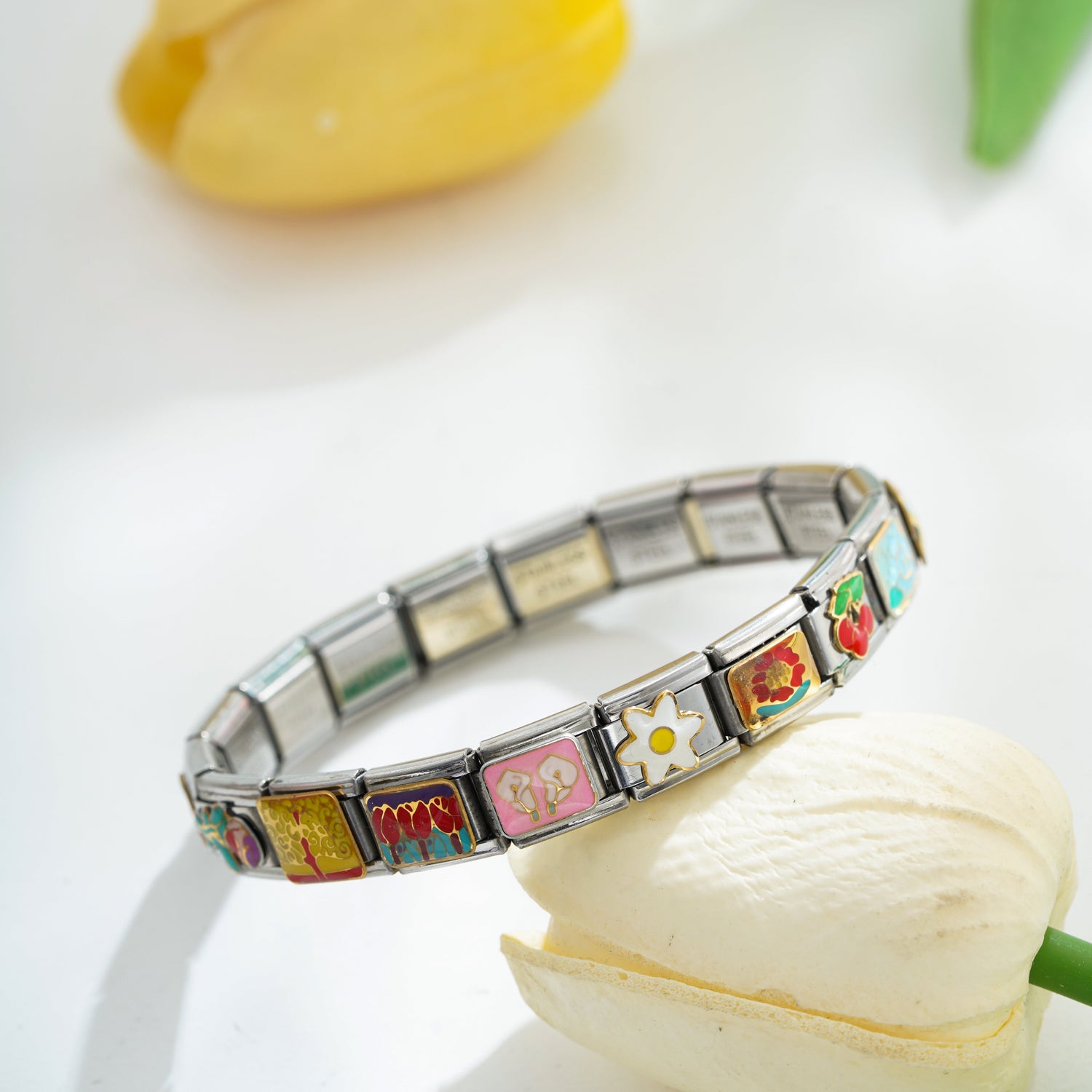 Italian charm bracelet with colorful charms styled in a bright lifestyle setting