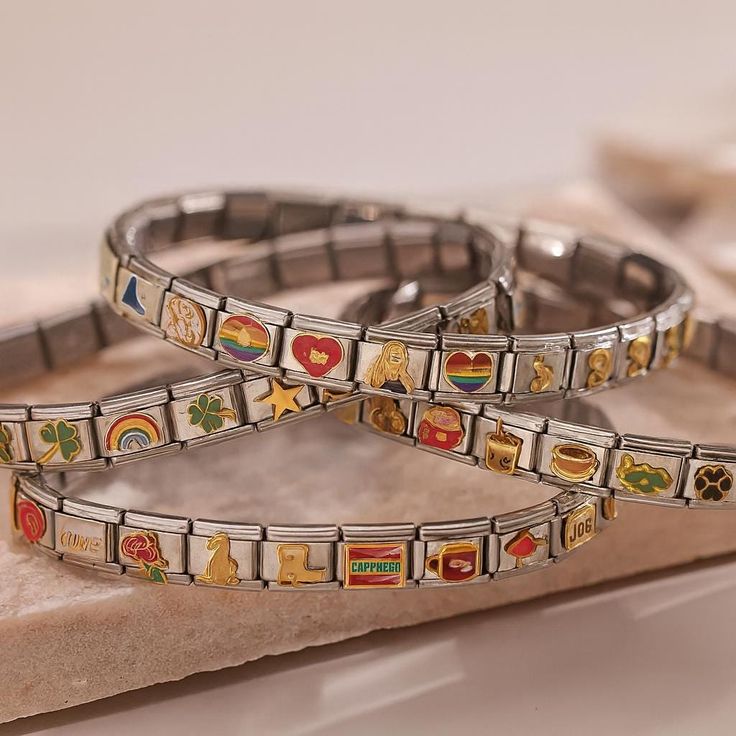 DIY Italian charm bracelet with colorful modular charms arranged on a table showing creative jewelry design at home