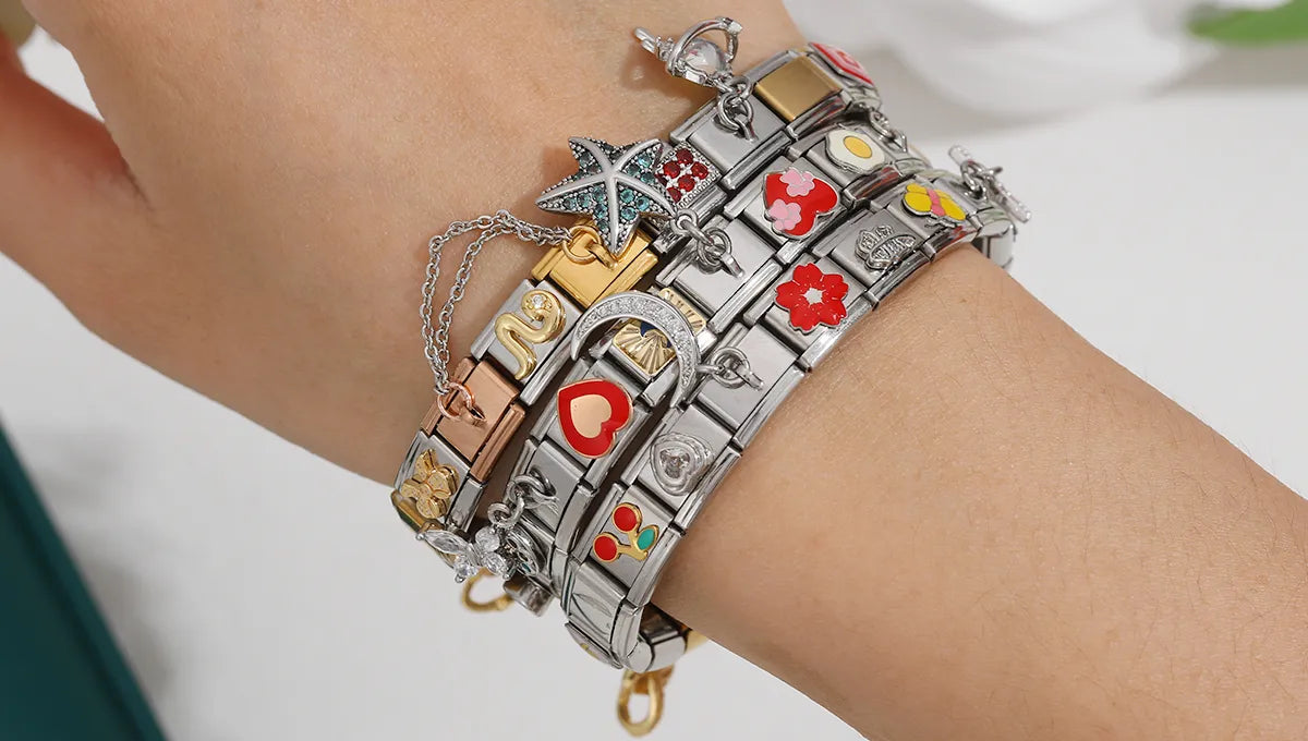 Three themed Italian charm bracelets styled on wrist, showcasing modular charm links in a fashion-forward look