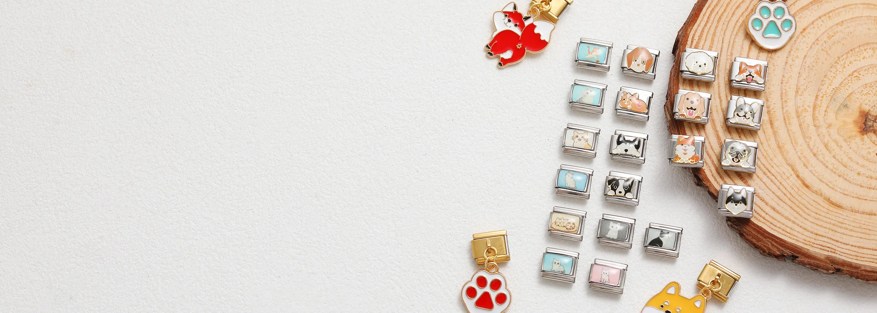 Italian charm bracelet links featuring various cute animal designs and colorful enamel paw charms, arranged on a white background with wooden decor