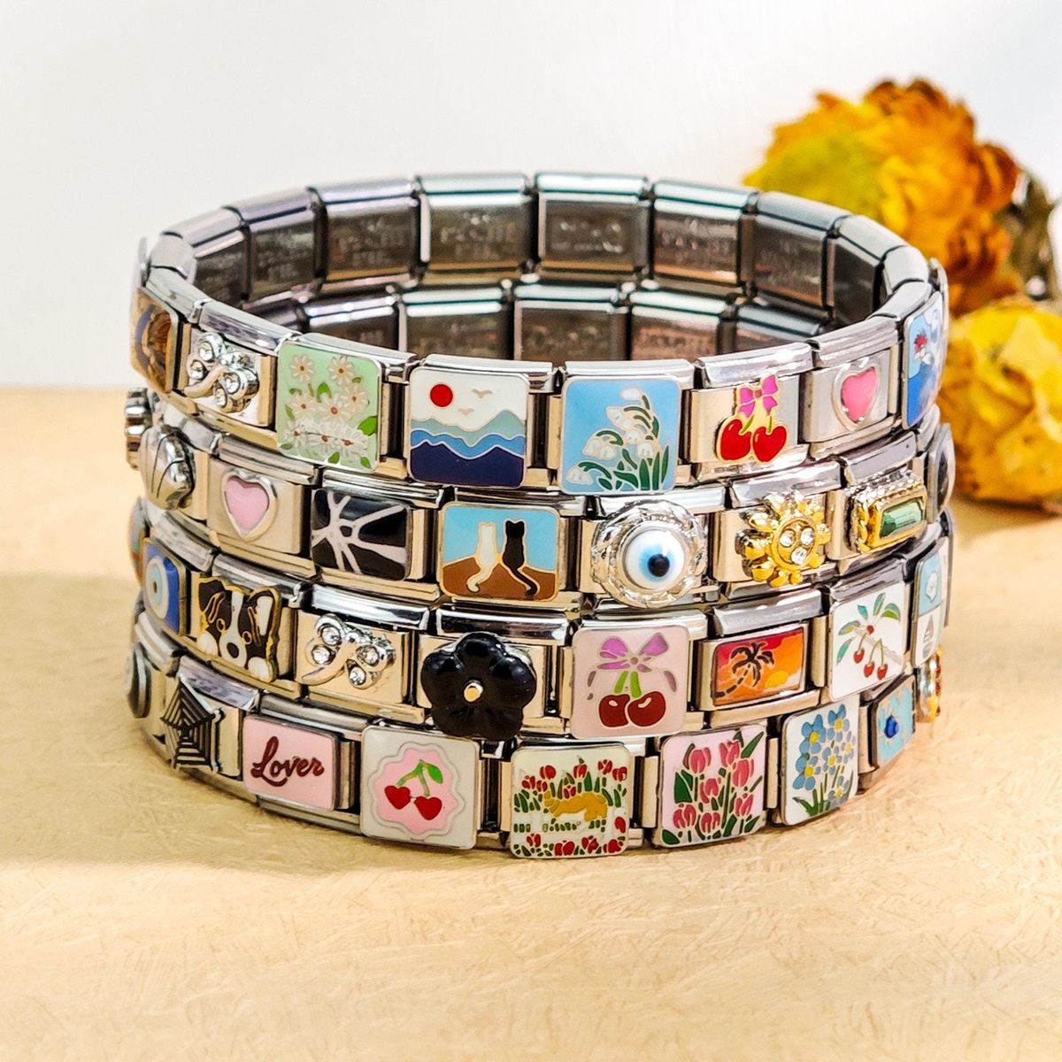 Sustainable modular Italian charm bracelets displayed on eco-friendly background