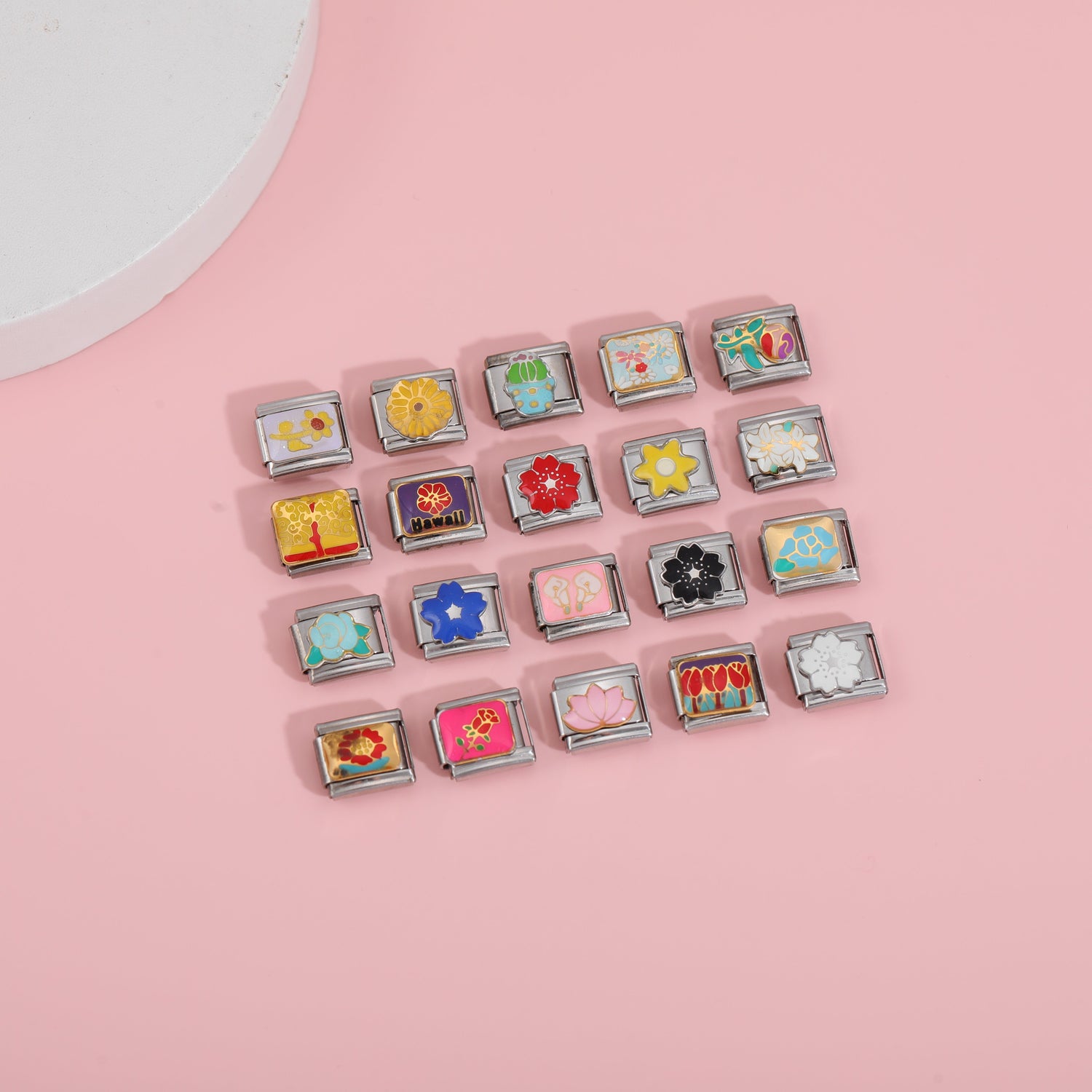 Italian charm bracelet flower charms collection with colorful floral designs on pink background