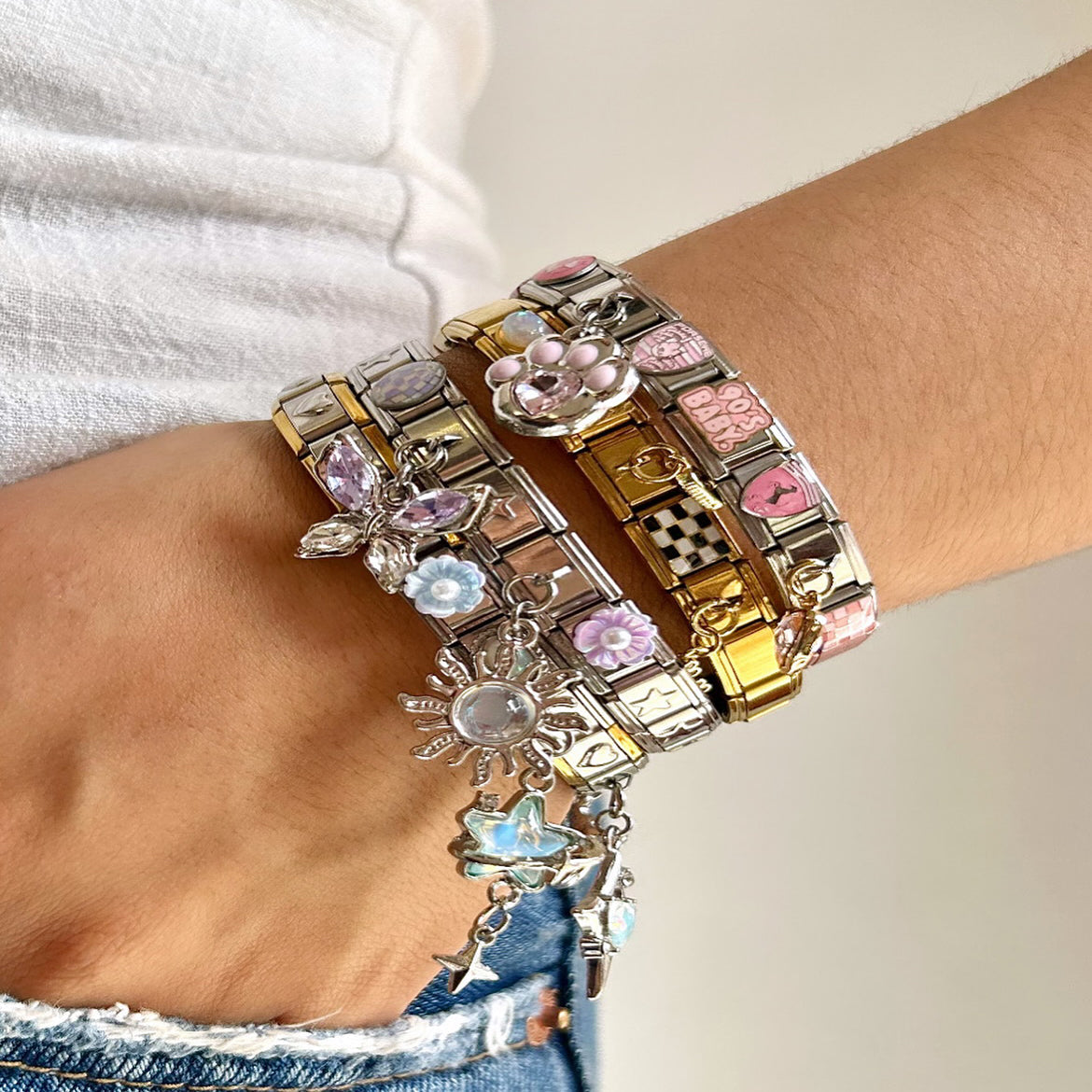 close up of Italian charm bracelets on a fashion influencer’s wrist under natural light