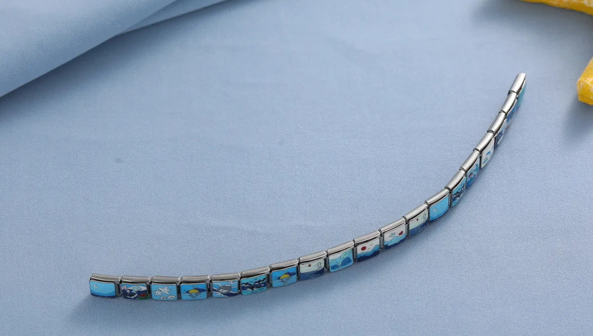 Italian charm bracelet with modular links on a minimalist blue background