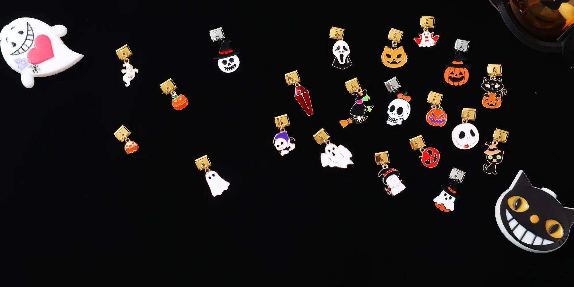 Halloween Italian charm bracelet dangle charms displayed on black background, featuring pumpkin, ghost, skull, witch, bat, black cat, haunted house, coffin and spider designs. Modular bracelet spooky jewelry gift collection by CHARMSDIY.